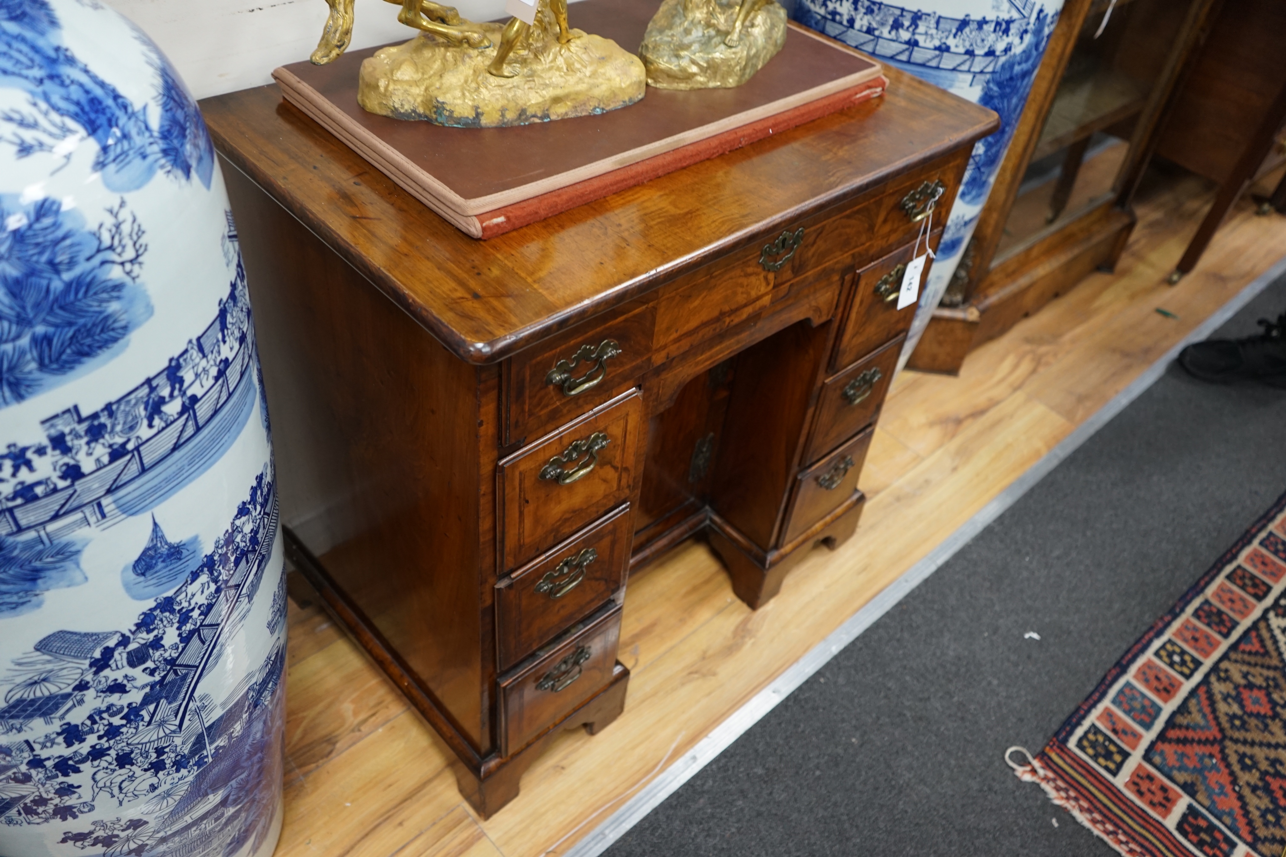 An 18th century and later walnut kneehole desk, width 78cm depth 50cm height 76cm